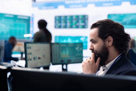 Multinational company manager examines online statistics at pc, reviewing reports and infographics to accomplish enterprise objectives. Consultant analyzes the current business situation.の写真素材