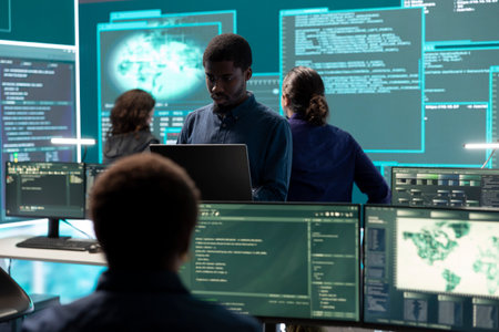 IT specialist looks at big screen for intelligence.