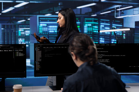 Technicians in data center workspace running system diagnostic tests and error checking utilities to...