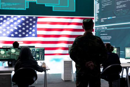 US army official working on ensuring servers protection and state secrets, protecting important hybrid warfare data in high tech agency office. Military soldier supervises hacking activity.の写真素材