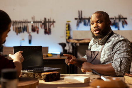 Carpenter in woodworking shop arguing with client about commissioned furniture assembling job....