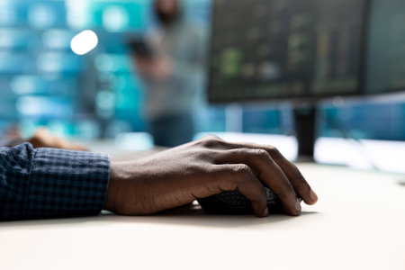 Governmental hackers at work monitoring cyber threats in high tech agency, implementing cybersecurity measures. IT expert focuses the importance of online privacy and malware protection.の写真素材