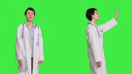 General practitioner welcoming patients and inviting them to come closer, greeting sick persons at checkup exam appointments. Doctor waving at people and asking them to approach her. Camera B.の写真素材