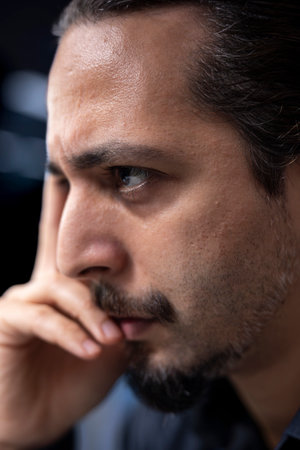 Man in data center checks for server performance issues caused by misconfigured applications. Extreme close up shot of IT expert in server hub fixing errors slowing down hardwareの写真素材