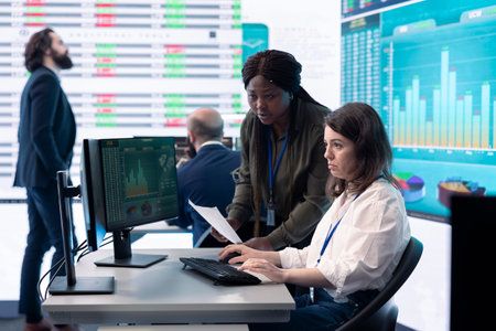 Coworkers team analyzing infographics to provide solutions on an issue affecting the project, looking to finish tasks before deadline. Business employees working together to ensure progress.の写真素材