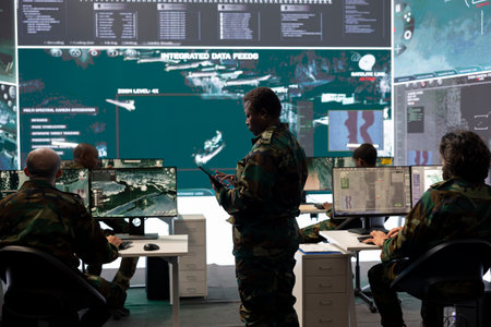 Woman recruit examining important battlefield information from a big screen in federal command center, military base of operations. Female soldier collecting and comparing data, satellite radar.の写真素材