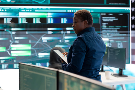 Cybersecurity specialists in a high tech office, focusing on cyber intelligence and secure network...