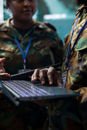 Army staff establishing new operating bases on a satellite world map visualization, ensure the national safety from the monitoring room at the base. Troopers operate CCTV radar footage. Close up.の写真素材