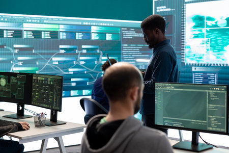 Governmental hackers breaching network security with advanced techniques, cyber defense in action. Team of IT experts working on gaining access to collect information, big screen.の写真素材