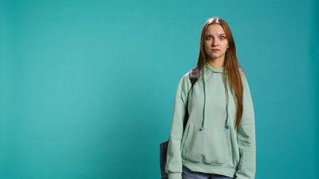 Young actress goofing around, switching emotions, trying different facial expressions, practicing for theatre class, studio background. Teenage woman making silly faces, camera Bの写真素材