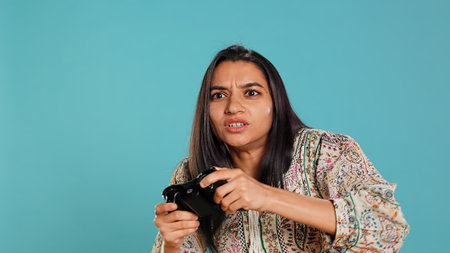 Gamer annoyed after losing online multiplayer videogame, being defeated by rival players. Indian...