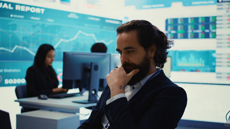 Project manager examining key performance metrics to ensure global business success, working with annual infographics to understand what needs improving. Multinational company activities. Camera B.の写真素材