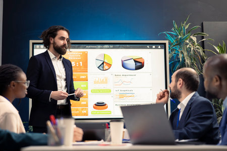 Financial expert briefing his staff members about new corporate objectives, presenting their budget...