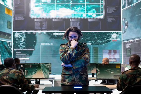 Young army conscript checking mission data and details on a hologram projection, studying operation...