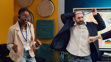 Satisfied coworkers dancing in the boardroom and celebrating a business development success. Employees feel excited and happy about their performance, helping organization grow. Camera A.の写真素材
