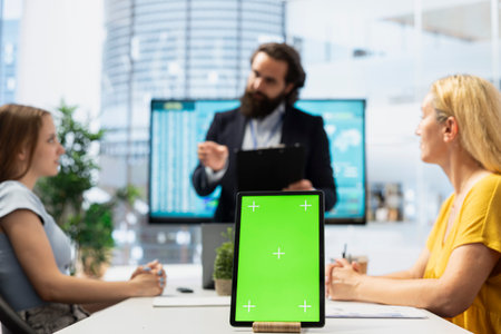 Focus on isolated screen tablet used by financial advisor in blurry background to calculate clients net worth. Close up shot of chroma key device used by agent to help family pick investmentsの写真素材