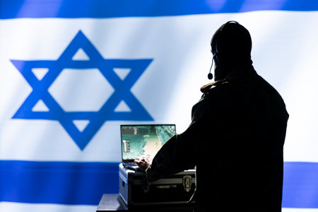 Israel Air Defense Forces early warning systems operator monitoring incoming enemy aerial attacks. IDF agent maintains air space superiority with radar during Middle East conflictsの写真素材