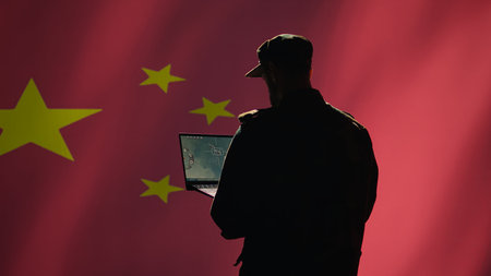Chinese soldier using radar detecting ballistic missile attacks and conducting general space surveillance and satellite tracking. CCP agent using military laptop software preventing rockets, camera Bの写真素材