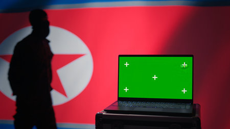 North Korea soldier using radar on green screen laptop to detect missiles during korean conflict. Pyongyang regime army soldier scanning rockets with chroma key notebook, close up shot, camera Bの写真素材