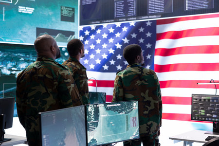 American military officers in cyber command center protect state secrets, manage classified information and engage in high tech digital warfare strategies to ensure cybersecurity and data protection.の写真素材