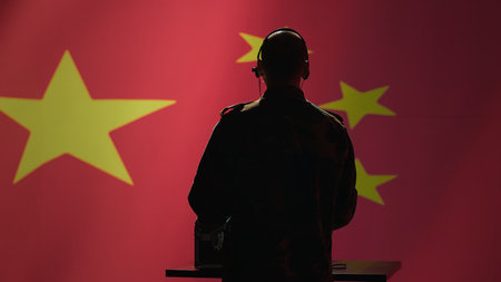 Military dispatcher in control center relays information from army intelligence analysts to troops on front lines. Radio communications operator in camouflage uniform talking in headset mic, camera Aの写真素材