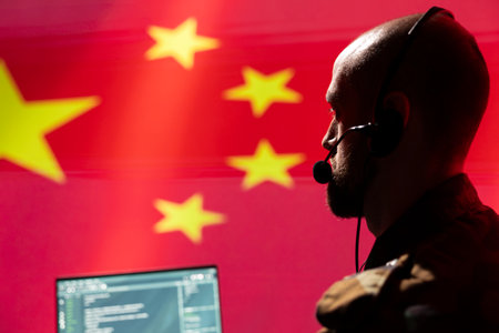 Military dispatcher in command center ready to respond to emergencies and communicate with troops on front lines. War telecommunications operator in uniform talking in headset mic, close upの写真素材