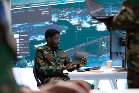 High tech military office with soldiers analyzing real time data, processing intelligence information and coordinating strategic operations to ensure national security. Working for army missions.の写真素材