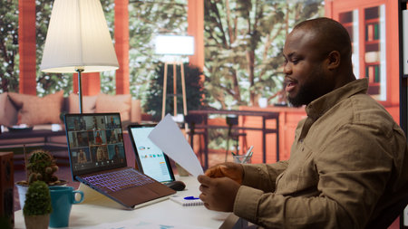 Businessman reviewing the financial reports with the shareholders on a videocall meeting at home. Specialists analyzing expansion plans to provide new business funds. Startup growth. Camera B.の写真素材
