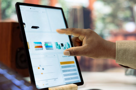 Young manager examining enterprise activity progress on achieving expansion goals, working from his home office. Businessman improving the workflow, accounting analytics plan. Close up.の写真素材
