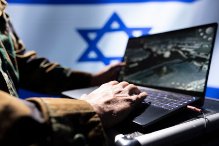 Israel Defense Forces army soldier using laptop, operating anti ballistic system designed to counter missiles threatening country. Close up of Israeli military unit defending against rocketsの写真素材
