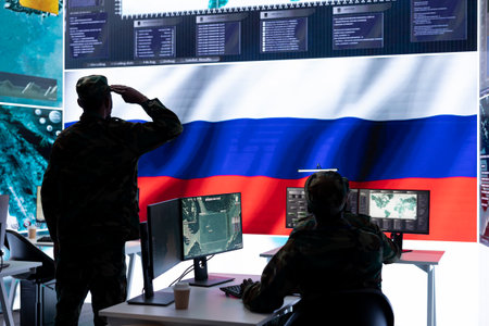 Russian army soldier presenting the official salute in operations room, inflicting propaganda and misinformation to cause fear among the people. Military spreading fake news during war.の写真素材