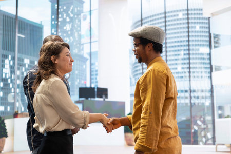 Skilled realtor salesman greeting business people for an office tour, examining new corporation workspace in an urban high class building. Development with real estate investment strategy.の写真素材