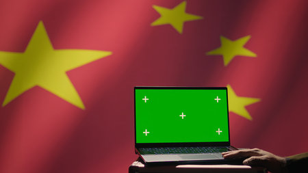 Chinese soldier using military tech on green screen laptop to identify threats from enemies. Army personnel using software on mockup notebook to communicate information to war front lines, camera Bの写真素材