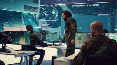 Staff sergeant providing mission files to brief his operational crew, working on gathering intelligence from surveillance systems. Prepares for various combat scenarios and outcomes. Camera B.の写真素材
