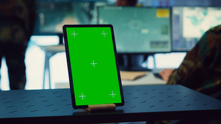 General headquarters monitoring room with a mockup screen on tablet, army officers safeguarding the coast line from enemy vessels. National guard machinists in control center. Camera A.の写真素材