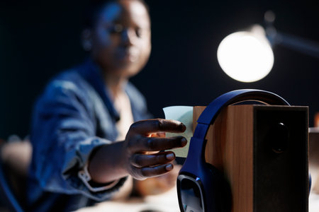 Picture of an African American female influencer with wireless headphones and a blue sticky note on...