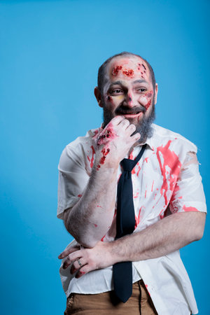 Actor dressed as horror movie zombie with worried look on face after forgetting lines. Man costumed...