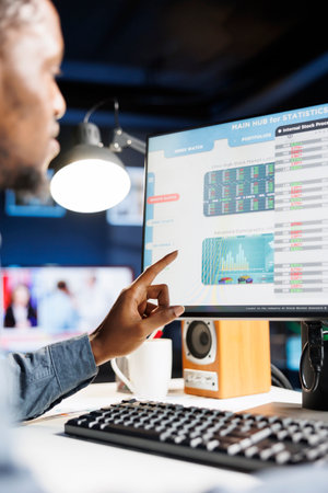 Analyst completing monthly income balance on computer, estimating expenses and investment in capital to boost earnings. Professional researcher investigates legal commerce figures and reports.の写真素材