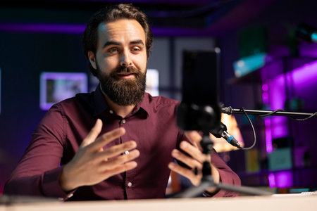 ASMR content creator using quality mic and cellphone on tripod to do anti stress video, using...