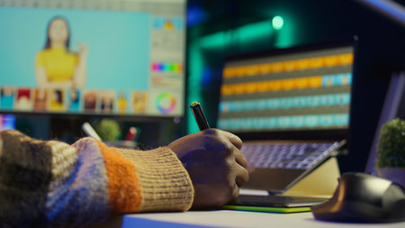 Professional man in creative setup at home using digital tools for graphic design and photo retouching, illustrating modern tech driven design industry. Advanced tech industry. Camera B.の写真素材