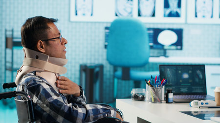 Indian patient with impairment and cervical foam attends a check up with specialist, discussing...