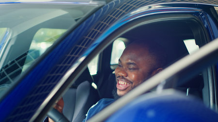 Happy client deciding to buy car after finishing test drive and enjoying driving vehicle. Cheerful...