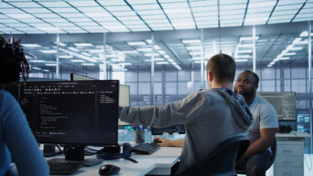 Manager discussing with programmer after making error in high tech data center. Supervisor talking...
