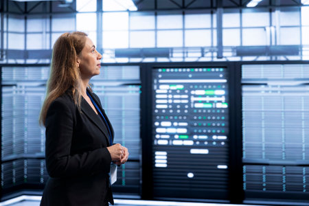 Engineer walking between server rows in data center, doing yearly infrastructure inspection. System...