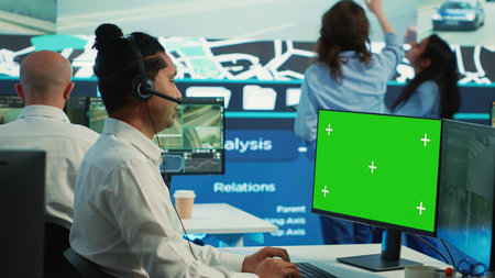Operator monitors delivery trucks next to a mockup screen, uses surveillance footage on CCTV cameras...
