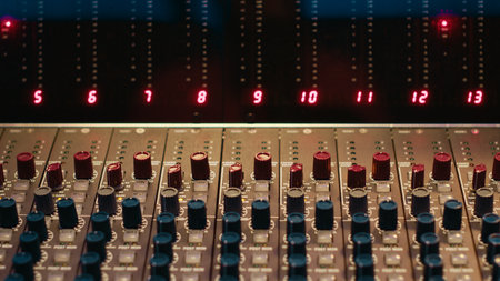 Empty professional studio with control desk mixer and pre amp knobs, music recording and editing...
