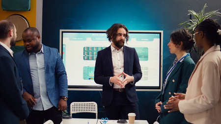 Group of enterprise colleagues meeting in a boardroom office, looking into strategies to improve...