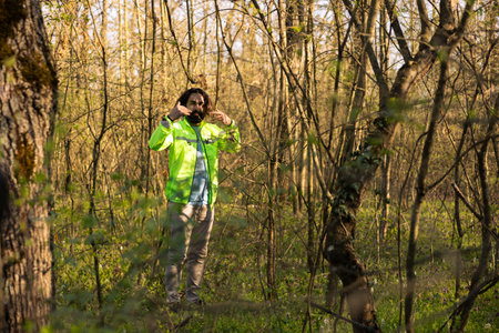 Search party leader guiding the team into the woods area to find evidence during manhunt mission,...