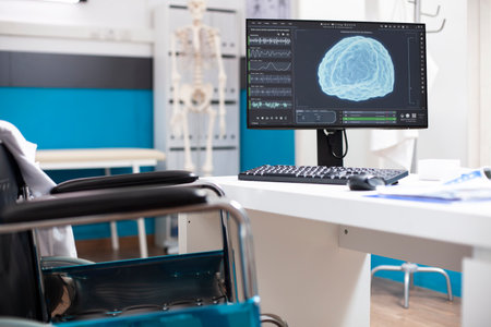 Empty clinic room has computer monitor showing detailed scan of the brain, emphasizing radiology...