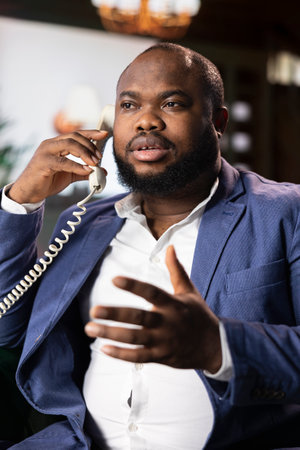 Government agent talks on a secure line with his contact to find crucial case information, protected...